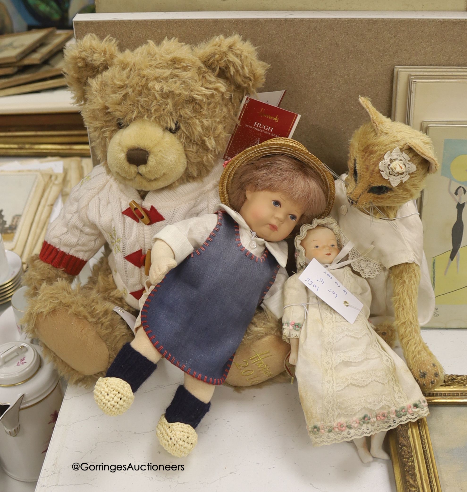 A modern Kathe Kruse doll with Burlington Berties cot and modern china baby doll and Harrods bear